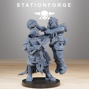 May include: A grey miniature figurine depicting a battle scene. One figure is armoured, wielding a weapon, while another attacks. The base is black, and the text "STATIONFORGE" is at the top, with a skull logo.