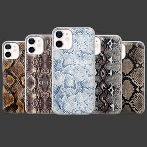 May include: Five phone cases with a snake skin pattern in various colors, including brown, tan, and blue. The cases are designed to fit a smartphone and have a clear border.