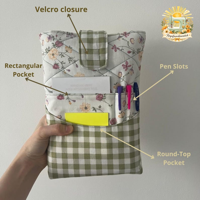 May include: A quilted fabric organizer featuring a white floral pattern with a green and white gingham flap, a velcro closure, a rectangular pocket, a round-top pocket, and three pen slots. The organizer includes labels for Velcro closure, Rectangular Pocket, Pen Slots, and Round-Top Pocket.