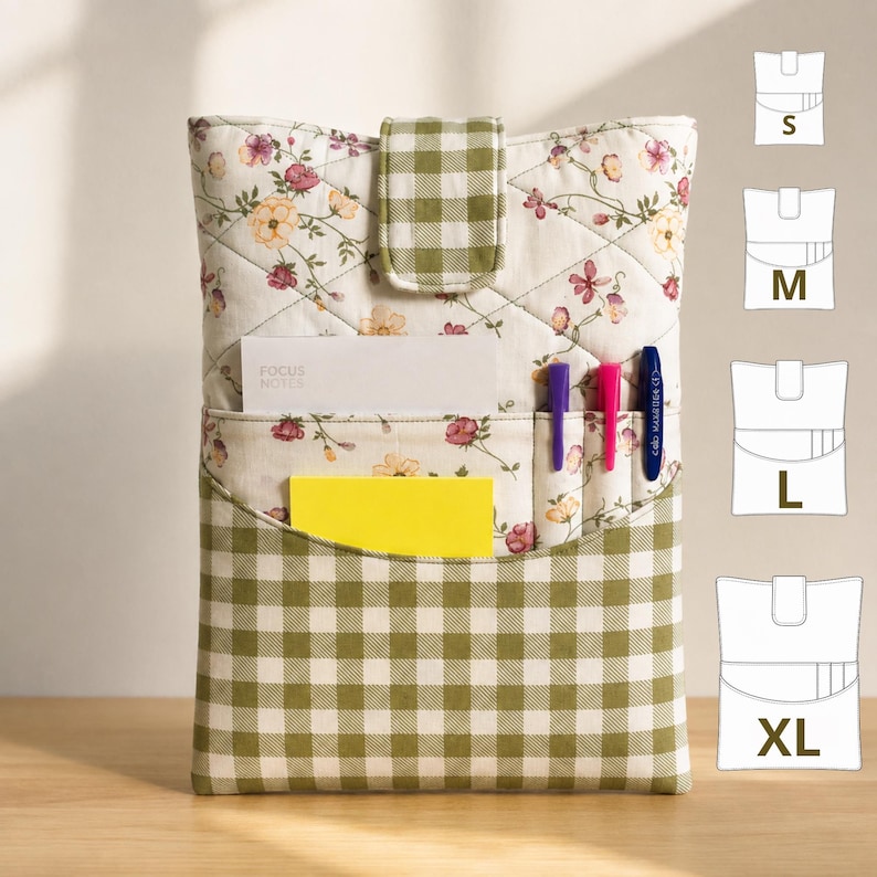 May include: A quilted fabric pouch featuring a cream background with a floral pattern and a green and white gingham check pocket and strap. The pouch contains a white notepad, a yellow sticky note, and two pens. Size chart icons for S, M, L, and XL are shown.