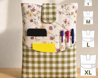 May include: A quilted fabric pouch featuring a floral pattern on a cream background with a green and white gingham flap closure. The front pocket holds a black smartphone, a yellow notepad, and two pens. Size chart icons for S, M, L, and XL are visible.