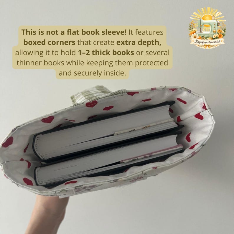 May include: A fabric book sleeve with boxed corners for extra depth, containing two thick books. The interior lining is white with a red heart pattern. Text on the image reads: This is not a flat book sleeve! It features boxed corners that create extra depth, allowing it to hold 1-2 thick books or several thinner books while keeping them protected and securely inside.