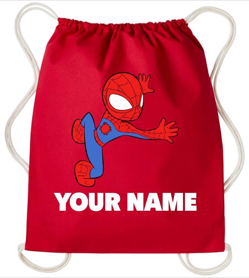 May include: A bright red drawstring backpack featuring a cartoon illustration of a red and blue spider-themed character in a dynamic pose. Below the character, the text YOUR NAME is printed in bold white capital letters. The bag has white cords.
