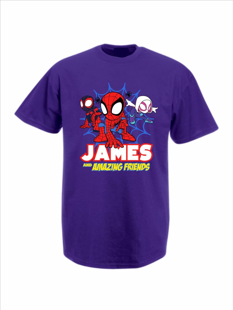 May include: A purple short-sleeved t-shirt featuring a graphic of three cartoon spider-themed characters in front of a blue web. Below the characters, the text reads JAMES AND AMAZING FRIENDS in bold white and yellow lettering on the front.