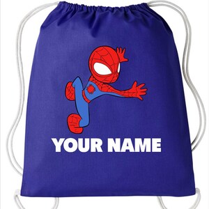 May include: A royal blue drawstring backpack featuring a cartoon illustration of a red and blue spider-themed character in a dynamic pose. Below the character, the text YOUR NAME is printed in bold white capital letters. The bag has white cords.