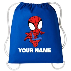 May include: A royal blue drawstring backpack featuring a cartoon illustration of a red and blue spider-themed character in a web-patterned suit. Below the character, the text "YOUR NAME" is printed in bold, white, uppercase sans-serif letters.