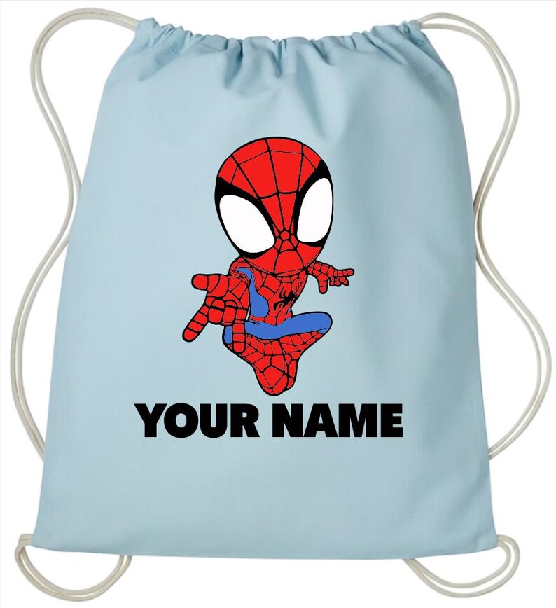 May include: A light blue drawstring backpack featuring a cartoon illustration of a red and blue spider-themed character in a crouching pose. Below the character, the text "YOUR NAME" is printed in bold, black, capital letters on the fabric.