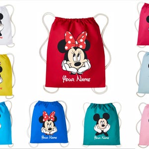 May include: A collection of eight drawstring bags in various colors including white, red, yellow, light blue, dark blue, teal, and pink. Each bag features a graphic of Mickey or Minnie Mouse and the printed text Your Name in red script.