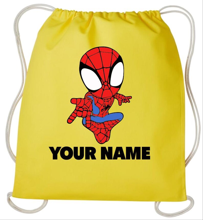 May include: A bright yellow drawstring backpack featuring a cartoon illustration of a red and blue spider-themed character with large white eyes. The text "YOUR NAME" is printed in bold black capital letters below the character graphic.