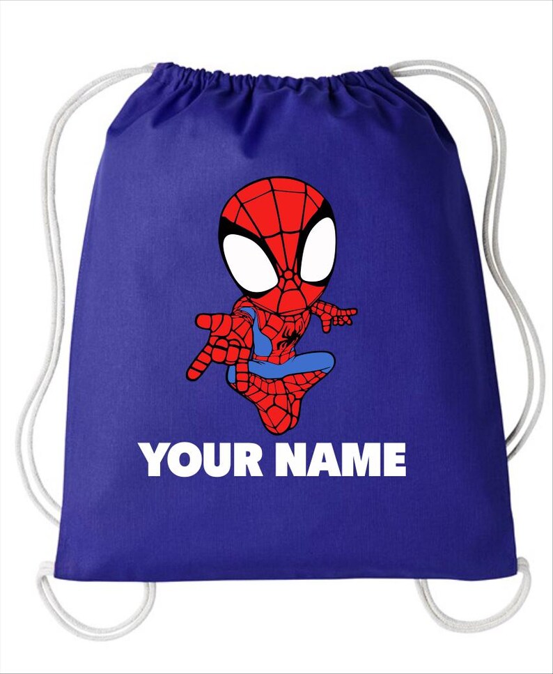 May include: A royal blue drawstring backpack featuring a cartoon illustration of a red and blue spider-themed character in a crouching pose. Below the character, the text "YOUR NAME" is printed in bold, white, capital letters.