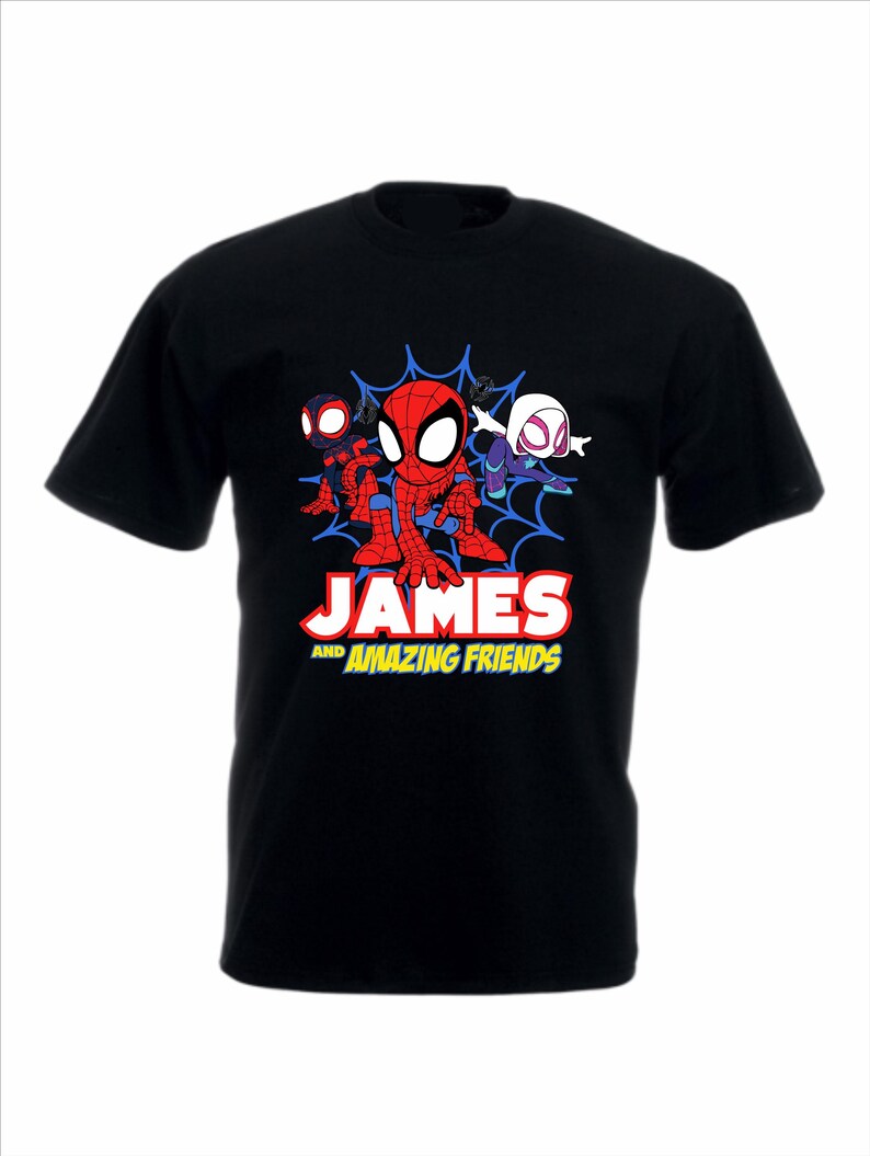 May include: A black short-sleeved t-shirt featuring a graphic of three cartoon spider-themed characters in front of a blue web. Below the characters, the text reads JAMES AND AMAZING FRIENDS in white and yellow block lettering on the chest.