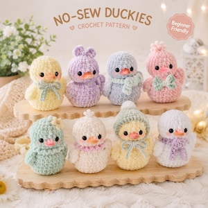 May include: Eight small, plush, crocheted ducklings in various pastel colors including yellow, lavender, blue, pink, mint, and white. They feature black bead eyes, orange beaks, and accessories like bows, scarves, and hats. Text reads NO-SEW DUCKIES CROCHET PATTERN.