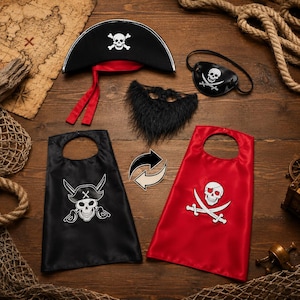 May include: A pirate costume set including a black hat with a white skull and crossbones, a black eye patch with a skull emblem, a black faux fur beard, and two capes, one black and one red, each featuring a white skull and sword graphic.