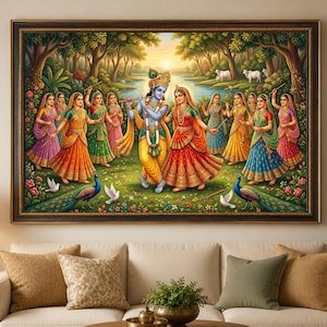 May include: A framed wall art print depicting a blue-skinned deity playing a flute alongside a woman in a red dress, surrounded by several women in colourful traditional attire, peacocks, white birds, and cows in a lush forest landscape.