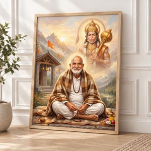 May include: A framed wall art print depicting a bearded man in white clothing and a brown plaid shawl sitting in a meditative pose. Behind him, a translucent figure of the deity Hanuman holds a golden mace. A temple with orange flags sits in the background.