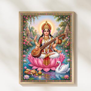 May include: A framed print of the Hindu goddess Saraswati, seated on a lotus flower in a serene pond. She holds a veena, a stringed instrument, and is surrounded by a swan, flowers, and temples. The artwork features vibrant colors and intricate details.