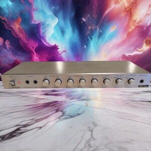 May include: Silver Technics stereo synthesizer mixing amplifier with multiple knobs and input jacks. The amplifier has the text "Technics" and "SH-8050" printed on the front panel. The background is a colorful nebula.