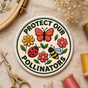 May include: A circular embroidered patch featuring a cream background with a dark green border. The text reads PROTECT OUR POLLINATORS in dark green. The design includes a central orange butterfly, a red ladybug, a yellow bee, and flowers.
