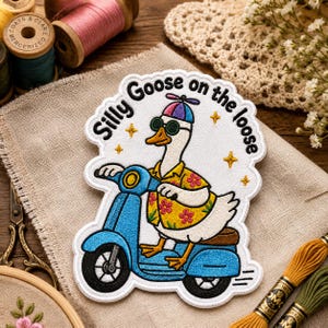 May include: An embroidered patch featuring a white goose wearing a yellow floral shirt, green sunglasses, and a multi-colored propeller hat. The goose is riding a blue scooter. The text "Silly Goose on the loose" is arched above the goose.