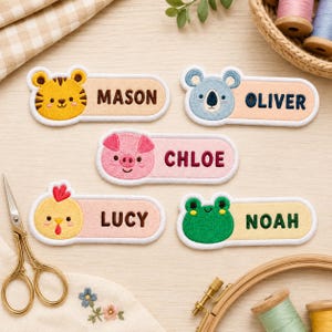 May include: Five rectangular embroidered name patches featuring cartoon animal faces on the left side. The patches display the names MASON with a tiger, OLIVER with a koala, CHLOE with a pig, LUCY with a chick, and NOAH with a green frog.