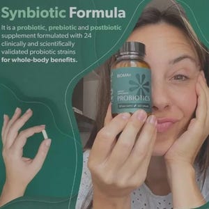 May include: A woman holding a bottle of "PROBIOTICS" dietary supplement and a capsule. The bottle is brown with a teal label and a black cap. The label includes the brand name "BIOMA" and the text "30 day supply 60 capsules". The background is teal.