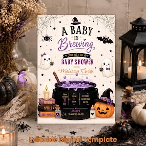 May include: A rectangular baby shower invitation template featuring the text A Baby is Brewing. The design includes a black cauldron with purple bubbles, two ghosts, a jack-o'-lantern, spiderwebs, and a stack of books labelled Potions, Spells, and Baby Magic.