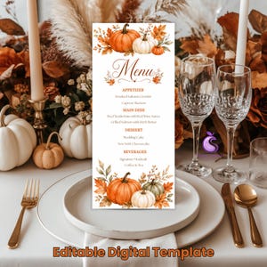 May include: A vertical rectangular menu card featuring watercolor illustrations of orange and white pumpkins surrounded by autumn leaves at the top and bottom. The text Menu is centered at the top, followed by sections for Appetizer, Main Dish, Dessert, and Beverages.