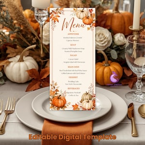 May include: A vertical rectangular menu card featuring an autumn theme with orange and white pumpkins, fall leaves, and branches. The text includes sections for Appetizer, Soup, Salad, Main Dish, Dessert, and Beverages with specific food items listed.