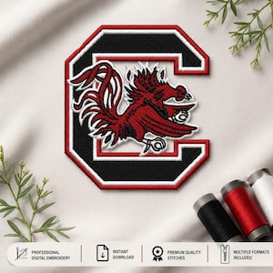 May include: An embroidered patch featuring a stylized red gamecock bird centered within a bold black block letter C. The design is outlined with thick white and red borders, showcasing detailed stitching throughout the graphic emblem.