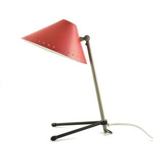 Red Pinocchio wall or table lamp designed in 1956 by H.Th.A. Busquet