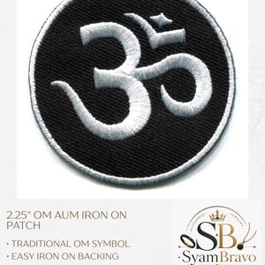 May include: A circular iron-on patch featuring a white embroidered Om symbol on a black background. The text reads 2.25" OM AUM IRON ON PATCH, TRADITIONAL OM SYMBOL, EASY IRON ON BACKING, BLACK AND WHITE EMBROIDERY, LIGHTWEIGHT FABRIC PATCH.