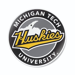 May include: A black and white circular sticker with the text "Michigan Tech University" and "Huskies" in a yellow and black font. The sticker features a gray outline of the Upper Peninsula of Michigan.