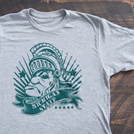 Nudge Printing Michigan State Gruff Sparty Money Msu Super Soft T Shirt Heather Light Grey Fan Shop Clothing