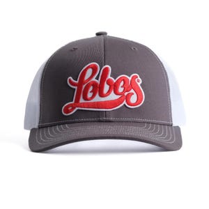 May include: Gray and white trucker hat with a red embroidered "Lobos" logo.