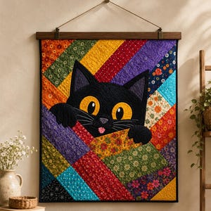 May include: A colorful quilt featuring a black cat with yellow eyes peeking out. The quilt has a patchwork design with various fabrics in orange, yellow, green, purple, and blue. The quilt is hung with a wooden bar and twine.