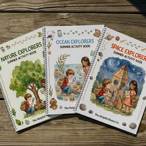 May include: Three spiral-bound activity books with colourful illustrations. Titles include "Nature Explorers," "Ocean Explorers," and "Space Explorers." Each book features children exploring nature, the ocean, and space. The Helpful Mama Co. is printed on the bottom.