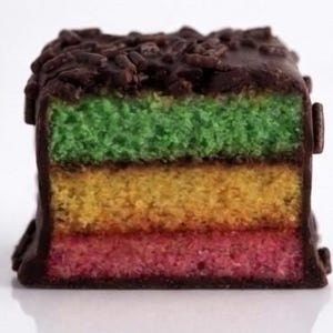 ~Classic Italian Rainbow Cookies~
Made with three delicate almond sponge layers in vibrant Italian flag colors, filled with sweet raspberry jam and finished in a smooth chocolate coating. Each pound includes approximately 22 cookies, making it perfect for gifting, celebrations, or indulging in a little bite of tradition.