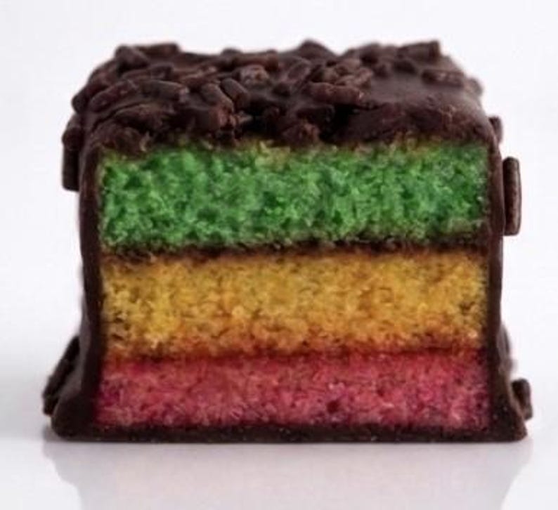 ~Classic Italian Rainbow Cookies~
Made with three delicate almond sponge layers in vibrant Italian flag colors, filled with sweet raspberry jam and finished in a smooth chocolate coating. Each pound includes approximately 22 cookies, making it perfect for gifting, celebrations, or indulging in a little bite of tradition.