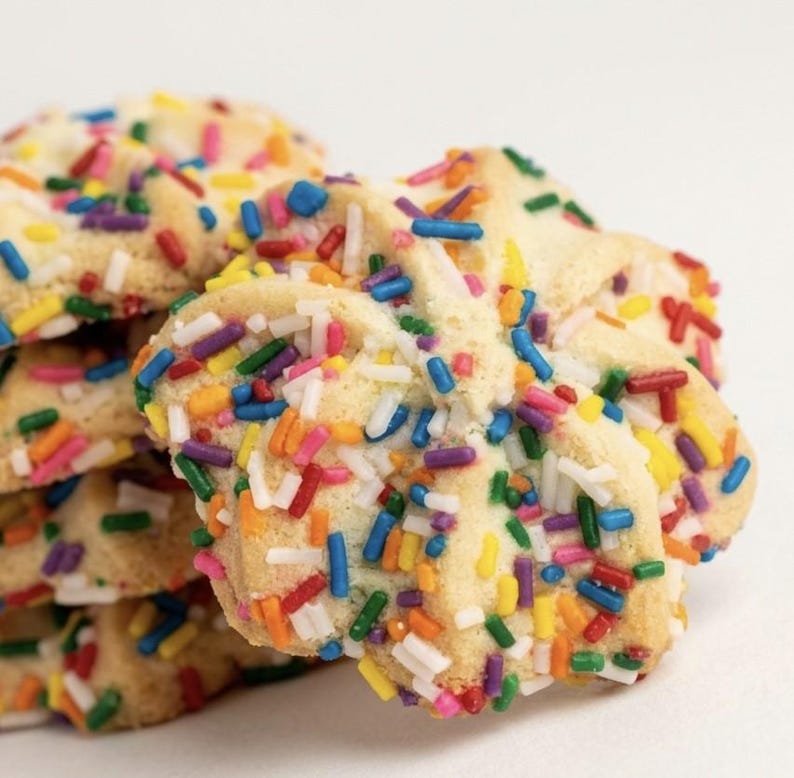 ~Italian Rainbow Spritz Cookies~ 
Delicately handcrafted Italian butter spritz cookies with a rich, buttery crumb and tender melt-in-your-mouth texture. Each cookie is finished with a vibrant coating of colorful sprinkles for a festive, elegant touch that balances nostalgic charm with gourmet refinement. Perfectly light, subtly sweet, and beautifully finished for gifting or entertaining.
Approximately 25 cookies per pound, made in small batches.