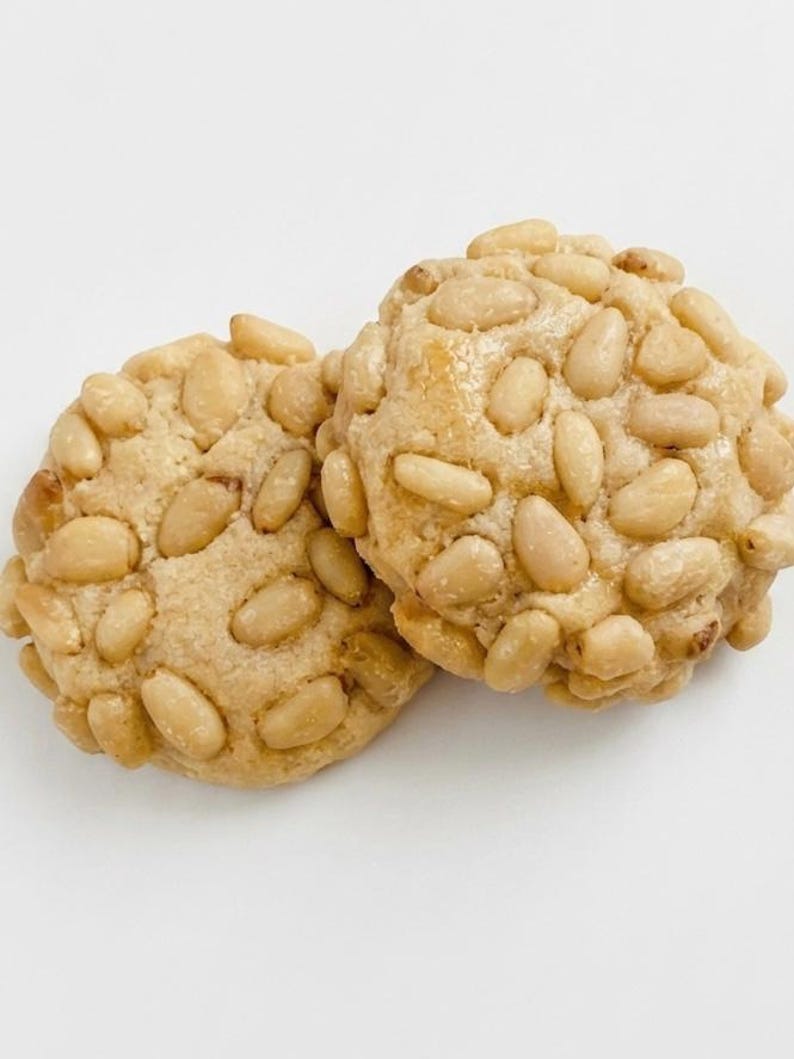 ~Pignoli Cookies~ 
Soft, bakery-style Pignoli Cookies ~a cherished Italian classic~ made with rich almond paste for a naturally sweet, chewy center and generously coated with golden, toasted pine nuts. Each bite is soft, nutty, and delicately crisp on the outside, delivering an indulgent, authentic bakery experience. Each pound includes approximately 36 cookies, making them perfect for gifting, holiday trays, or an elegant everyday treat.