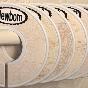 May include: Set of eight white plastic hanger dividers with a vintage map design and black text. The first divider has the word "Newborn" printed on it. The last divider has the words "Porto Rico" printed on it.