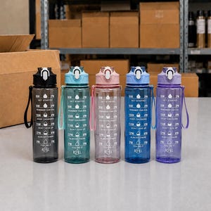 May include: Five translucent plastic water bottles with flip-top lids and carrying straps, arranged in a row. Each bottle features white printed time markers and motivational text including Get Started, Keep Chugging, and You Did It, with water drop icons.