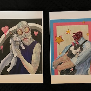 May include: Two illustrations of people holding cats. The first illustration is of a person with green skin and large eyes holding a white cat with black markings. The background is black with pink hearts. The second illustration is of a person with a red, bloody head holding a black and white cat. The background is pink, blue, and yellow with stars.