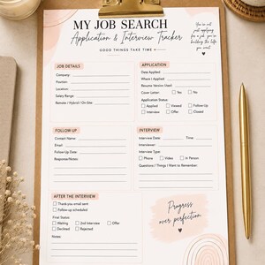 May include: A printed job search application and interview tracker on a brown clipboard with a gold clip. The document features sections for job details, application status, follow-up, interview notes, and after-interview steps with soft pink accents.