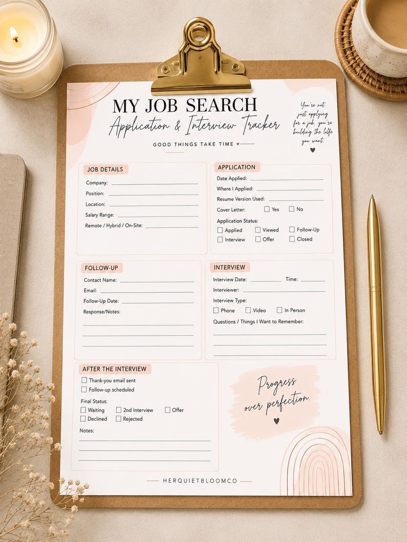 May include: A printed job search application and interview tracker on a brown clipboard with a gold clip. The document features sections for job details, application status, follow-up, interview notes, and after-interview steps with soft pink accents.
