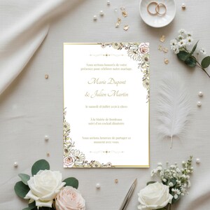 Peut inclure: Une invitation de mariage avec une bordure dorée et des motifs floraux dans les coins. L'invitation comprend les noms "Marie Dupont & Julien Martin" et la date "le samedi 18 juillet 2016 à 15h00". L'invitation est entourée de fleurs et d'alliances.