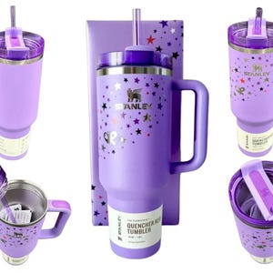May include: A light purple Stanley Quencher H2.0 tumbler with a handle, a clear straw, and a purple lid. The tumbler features a metallic star pattern and the Stanley logo. A product label on the base indicates a capacity of 40 oz / 1.18 L.