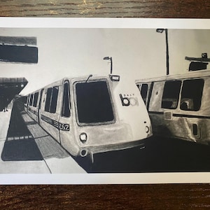 May include: A black and white charcoal drawing of a BART train at a station platform. The train features the number 262 on its side and the BART logo on the front. The scene includes a station sign, platform lighting, and a second train car.