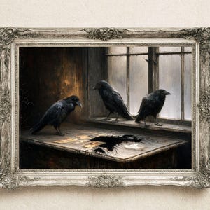 May include: A framed wall art print depicting three black ravens in a dimly lit room. One raven stands on a wooden table next to scattered cards and a dark ink spill, while two others perch on a window sill overlooking a rainy, overcast exterior.