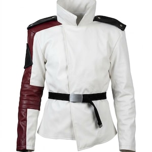 Könnte beinhalten: Eine weiße Jacke mit hohem Kragen, schwarzen Schulterklappen und einem rechten Ärmel mit kastanienbraunen und schwarzen Einsätzen. Die Jacke verfügt über einen schwarzen Gürtel mit silberner Schnalle in der Taille, was ein strukturiertes, mehrschichtiges Erscheinungsbild mit ausgeprägten Farbblöcken erzeugt.